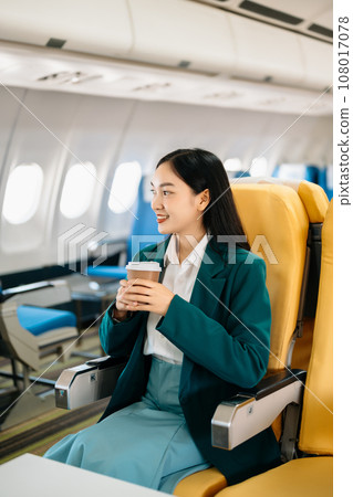 Young Asian executive excels in first class, multitasking with digital tablet, laptop and smartphone. Travel in style, work with grace. in morning light. Young Asian executive excels in first class, multitasking with digital tablet, laptop and smartphone. Travel in style, work with grace. in morning light. 108017078