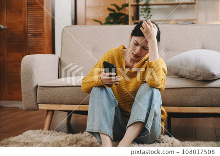 woman sit Depression Dark haired pensive glance Standing by window and anxiety Copy space. at home woman sit Depression Dark haired pensive glance Standing by window and anxiety Copy space. at home 108017508