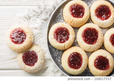 Thumbprint or Hallongrottor Swedish Raspberry Jam Cookies closeup on the plate. Horizontal top view Thumbprint or Hallongrottor Swedish Raspberry Jam Cookies closeup on the plate. Horizontal top view 108017557