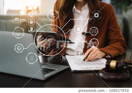 justice and law concept.Male judge in a courtroom  the gavel, working with smart phone and laptop and digital tablet computer on table with VR icon. 108017658