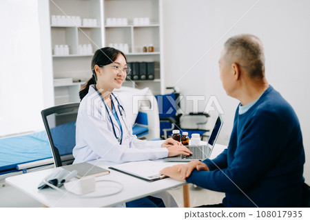 Serious Asia female doctor using clipboard is delivering great news talk discuss results or symptoms with female patient in clinic or hospital . 108017935