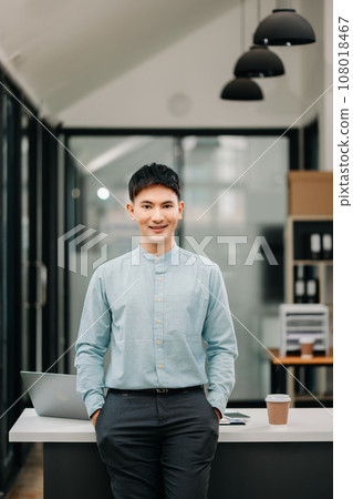 Young attractive Asian male office worker business smiling at camera in office 108018467