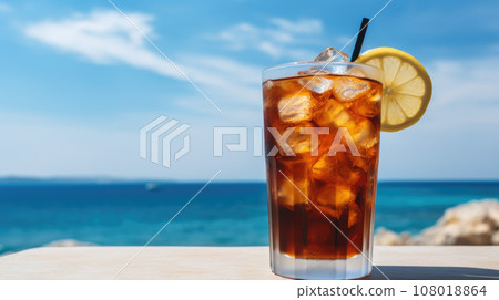 Summer cocktails, sea resort concept. Glass of iced tea. Long island cocktail on tropical beach Summer cocktails, sea resort concept. Glass of iced tea. Long island cocktail on tropical beach 108018864