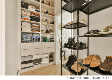 the inside of a walk - in closet with shoes and other items on shelves, as well as they do 108019017