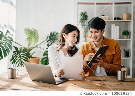 Portrait of success Asian business people working together in home office. Couple teamwork startup concept.. 108019124
