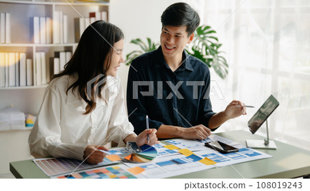 Asian businessman and woman people meeting in office. Employee brainstorm and work as team, plan and discuss project by point on paper and tablet. Asian businessman and woman people meeting in office. Employee brainstorm and work as team, plan and discuss project by point on paper and tablet. 108019243
