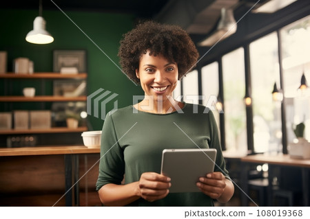 Half-length portrait of cheerful African American businesswoman in business attire holding a tablet. Happy smiling young lady, successful entrepreneur or employee working in office or coworking cafe. 108019368