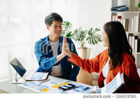 UX developer and ui designer brainstorming about mobile app interface wireframe design with customer breif and color code at office.. 108019561