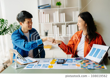 Asian businessman and woman people meeting in office. Employee brainstorm and work as team, plan and discuss project by point on paper and tablet. 108019562