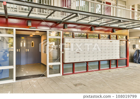 a building that has been painted red, white and blue with the door open to reveal an entry way through it a building that has been painted red, white and blue with the door open to reveal an entry way through it 108019799
