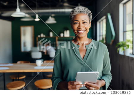 Half-length portrait of cheerful African American businesswoman in business attire holding a tablet. Happy smiling young lady, successful entrepreneur or employee working in office or coworking cafe. 108019885