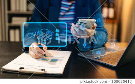 Man using chatbot in computer and tablet smart intelligence Ai.Chat with AI Artificial Intelligence, developed by OpenAI generate. Futuristic technology, robot in online system. neon light in dark Man using chatbot in computer and tablet smart intelligence Ai.Chat with AI Artificial Intelligence, developed by OpenAI generate. Futuristic technology, robot in online system. neon light in dark 108020413