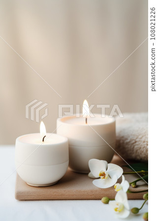 Luxury lighting aromatic scented glass candle display on the grey table in the white bedroom 108021226