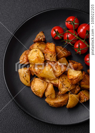 Delicious crispy fried potato wedges with salt, spices and herbs 108022103