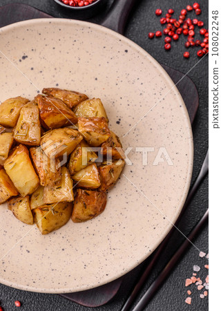 Delicious crispy fried potato wedges with salt, spices and herbs 108022248