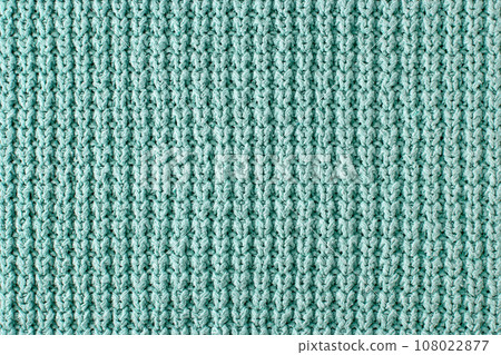 Texture of a rough knitted sweater close-up. Turquoise knitted backdrop for layout design Texture of a rough knitted sweater close-up. Turquoise knitted backdrop for layout design 108022877
