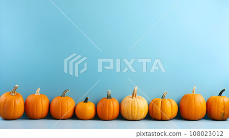 Festive thanksgiving decor of pumpkins, berries and leaves on a blue background with copy space for text 108023012
