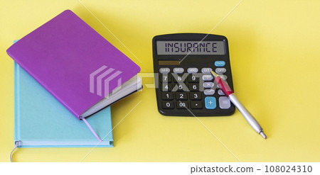 Colored notepads, a pen and a calculator with the inscription Insurance lie on a yellow background. Colored notepads, a pen and a calculator with the inscription Insurance lie on a yellow background. 108024310