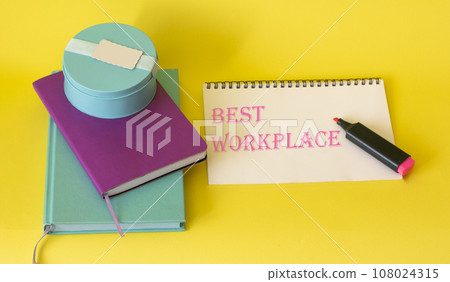 Bright notebooks on a yellow background and text on paper the best place to work Bright notebooks on a yellow background and text on paper the best place to work 108024315