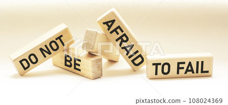 text DO NOT BE AFRAID TO FAIL text on wooden blocks and white background. Motivation for success text DO NOT BE AFRAID TO FAIL text on wooden blocks and white background. Motivation for success 108024369