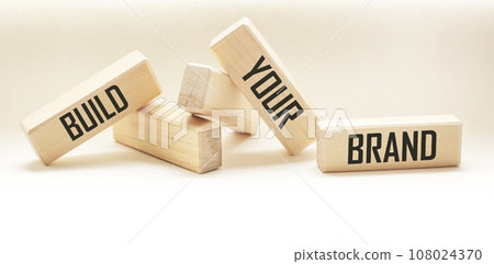 BUILD YOUR BRAND symbol of your brand on a wooden block. BYB Concept Words. Copy space. BUILD YOUR BRAND symbol of your brand on a wooden block. BYB Concept Words. Copy space. 108024370