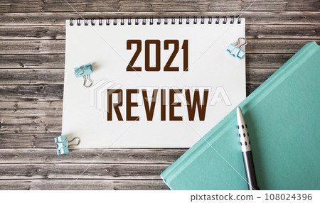 2021 looking back text on white card on office desk. Year highlights concept. Top view. 2021 looking back text on white card on office desk. Year highlights concept. Top view. 108024396