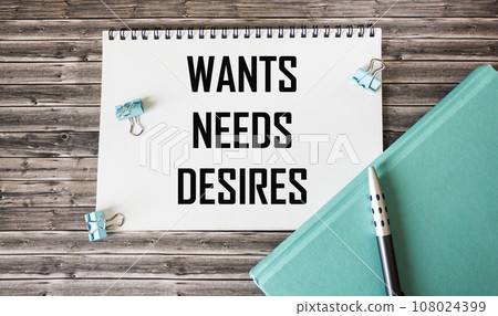 Symbol of needs and desires. Word concept Wants Desire needs on wooden blocks. Symbol of needs and desires. Word concept Wants Desire needs on wooden blocks. 108024399