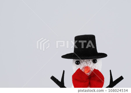 Snowman in a hat over white background. Merry Christmas and Happy New Year greeting holiday card. Christmas holiday wallpaper. Snowman in a hat over white background. Merry Christmas and Happy New Year greeting holiday card. Christmas holiday wallpaper. 108024534