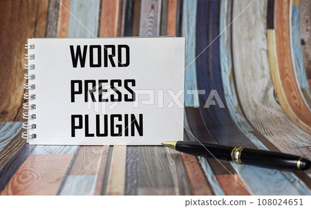 On a vintage background, a white notebook with the text WORD PRESS PLUGIN 108024651