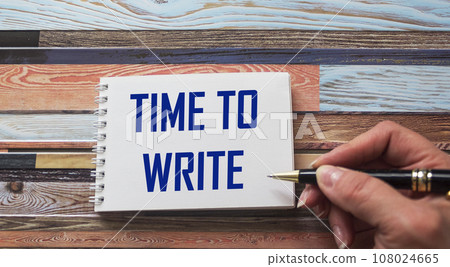 The text TIME TO WRITE is written by a female hand on a notebook. Education and business concept. 108024665