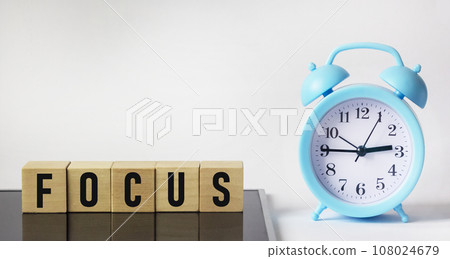 Wooden cubes lie on a black background. Cubes make up the word FOCUS. Business concept. Wooden cubes lie on a black background. Cubes make up the word FOCUS. Business concept. 108024679