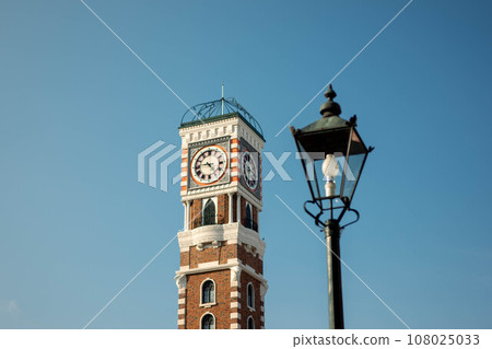 Clock tower and retro street lamp Clock tower and retro street lamp 108025033