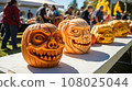 Pumpkin carving contest at a community event, showcasing creative designs. 108025044