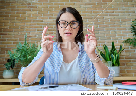Young talking woman looking at webcam recording video blog vlog Young talking woman looking at webcam recording video blog vlog 108026448