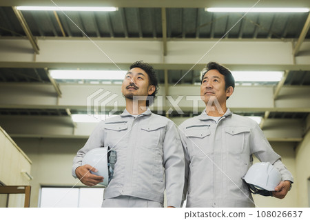 two middle-aged workers two middle-aged workers 108026637