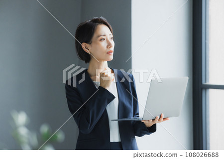 Business woman troubled watching a personal computer 108026688