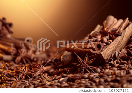 Roasted coffee beans with cinnamon sticks, anise, and nutmeg. 108027131
