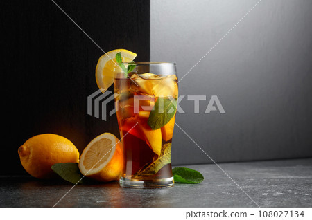 Iced tea or a summer refreshing drink with ice, mint, and lemon. 108027134