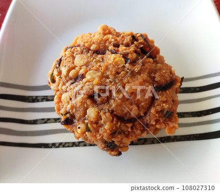 Vadai or (vada, wada, vade), pronounced 'Wah-dei', is a south Indian food. This is a vadai made of dal and potatoes and fried in cooking oil. Vadai or (vada, wada, vade), pronounced 'Wah-dei', is a south Indian food. This is a vadai made of dal and potatoes and fried in cooking oil. 108027310