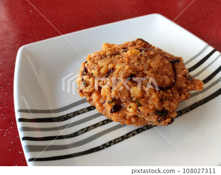 Vadai or (vada, wada, vade), pronounced 'Wah-dei', is a south Indian food. This is a vadai made of dal and potatoes and fried in cooking oil. Vadai or (vada, wada, vade), pronounced 'Wah-dei', is a south Indian food. This is a vadai made of dal and potatoes and fried in cooking oil. 108027311