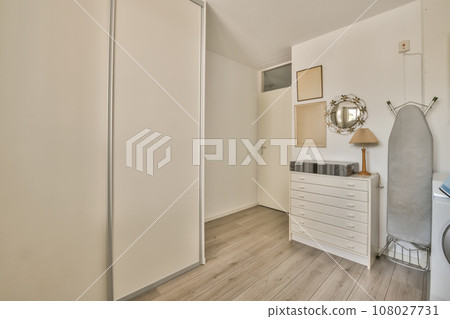 a bedroom with white walls and wood flooring the room is clean and ready for guests to use as well 108027731