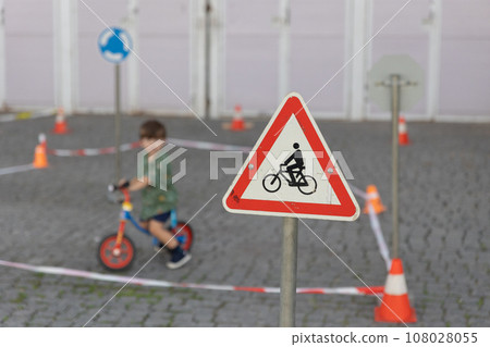 Warning sign near children riding bikes. Warning sign near children riding bikes. 108028055