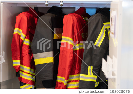 Hanging firefighter jackets and helmets. 108028076