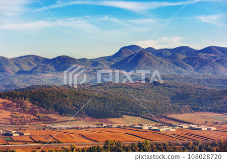 landscape of romania in autumn. stunning mountainous countryside scenery with forested hills in morning light. rural fields in the valley landscape of romania in autumn. stunning mountainous countryside scenery with forested hills in morning light. rural fields in the valley 108028720