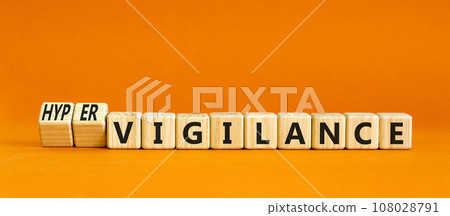 Vigilance or hypervigilance symbol. Concept words Vigilance Hypervigilance on wooden blocks. Beautiful orange table orange background. Psychology vigilance hypervigilance concept. Copy space. Vigilance or hypervigilance symbol. Concept words Vigilance Hypervigilance on wooden blocks. Beautiful orange table orange background. Psychology vigilance hypervigilance concept. Copy space. 108028791