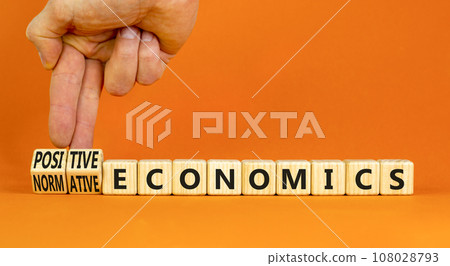 Positive or normative economics symbol. Concept words Positive economics Normative economics on blocks. Beautiful orange background. Businessman hand. Business Positive normative economics concept. Positive or normative economics symbol. Concept words Positive economics Normative economics on blocks. Beautiful orange background. Businessman hand. Business Positive normative economics concept. 108028793