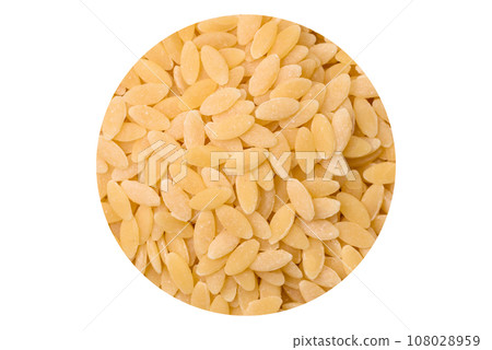 Raw whole grain orzo pasta as an ingredient for a delicious dish Raw whole grain orzo pasta as an ingredient for a delicious dish 108028959