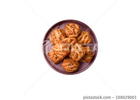 Delicious crispy mini puffs with sausage or meat with salt, thyme and sesame 108029001