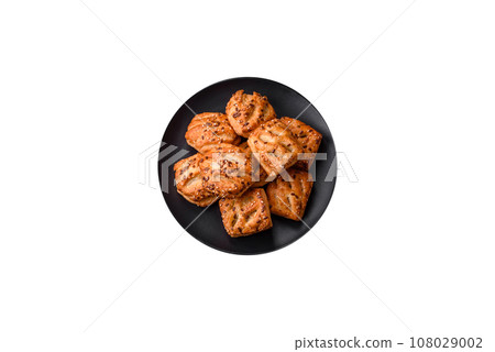 Delicious crispy mini puffs with sausage or meat with salt, thyme and sesame 108029002
