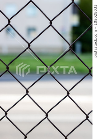 Metal mesh on the background of the road Metal mesh on the background of the road 108029033